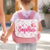 On-body Back View of a Toddler Girl Wearing Nameli Personalised Pink Corduroy Backpack with Quilted Floral Flap